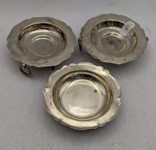 A pair of three footed pin dishes having twin handles stamped 900, together with one other 181.1g