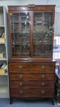 A Regency mahogany secretaire bookcase having twin glazed doors above a fitted secretaire drawer and