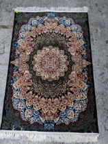 A contemporary small Persian style, machine woven rug, floral design surrounding a central floral