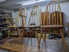 A set of four Ercol beech and elm Windsor spindle back chairs comprising three standard and a carver