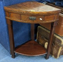 An early 20th century mahogany bow fronted corner table having a single drawer and shelf below, 86.