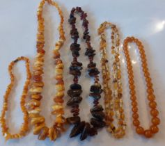 Four late 20th Century amber bead necklaces to include rough cut yellow amber beads together with