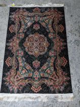 A contemporary small Persian style machine woven rug, floral design around a central medallion,