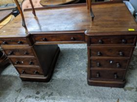 A Victorian mahogany breakfront desk with nine drawers, on a plinth 75cm h x 137cm w x 65cm d