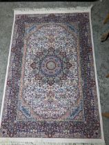 A contemporary small Persian style machine woven rug, floral design with boarders, surrounding a