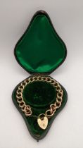 A 9ct gold late 19th century /20th century gold bracelet with a padlock clasp in the original fitted