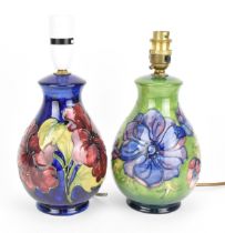 Two Moorcroft pottery lamps in the 'Hibiscus' and 'Clematis' patterns, each of baluster form with