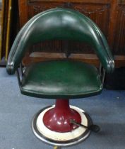 A retro barber's leather tub chair, in green leather with pump lever to the spreading circular red