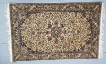 A Persian hand woven silk Isfahan rug, with shah abbas floral motifs on a cream ground, multiple