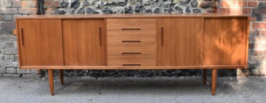 A mid century Swedish teak sideboard by Nils Jonsson for Troeds, of rectangular outline, fitted with