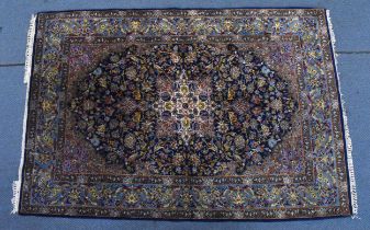 A Persian hand-woven Isfahan silk rug, the blue ground with central floral medallion, surrounded