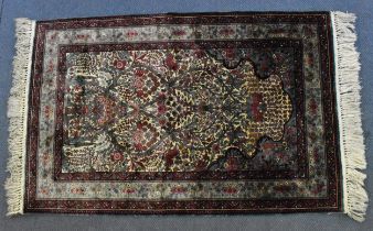 A handwoven Indian Kahmir silk rug by Gulam Mohidin & Son, with mihrab design with extensive foliate