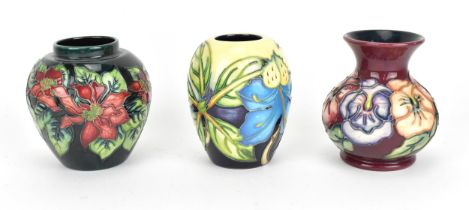A small trio of Moorcroft pottery vases, to include 'Pansy' by Rachel Bishop, 'Poinsettia', and '