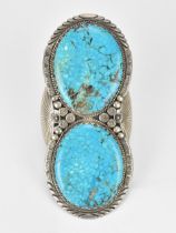 A large Native American white metal and turquoise cuff bracelet, with two large polished stones in a