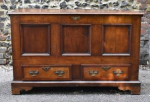 A late 18th century George III oak mule chest, the hinged lid opening to reveal storage within,
