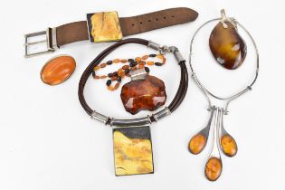 A collection of silver-mounted amber design jewellery, to include a leather strap bracelet with MG