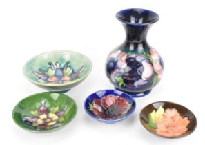 A collection of Moorcroft pottery, comprising a baluster vase in the 'Anemone' pattern by Walter
