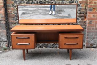 A mid century teak Fresco dressing table by G-plan, with rectangular mirror above a single frieze