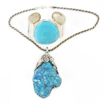 A Native American Navajo white metal and fox mine turquoise pendant on chain,