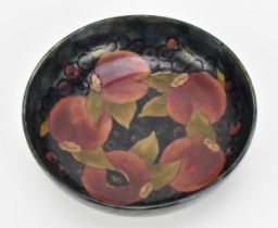 A William Moorcroft (1872-1945) pottery bowl in the 'Pomegranate' pattern, circa 1935, of circular