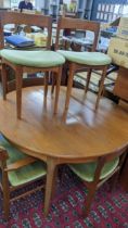 A mid 20th century teak extending dining table, 75cm h x 121.5cm w (unextended) and a matching set