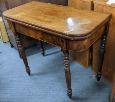 A Regency mahogany fold over tea table having boxwood inlaid and on turned legs 73.5hx8.5w Location: