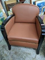 An Art Deco black painted wooden framed arm chair with a brown faux leather upholstery Location: