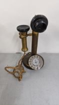 An early/mid 20th century brass candlesticks Rotary dial telephone Location: