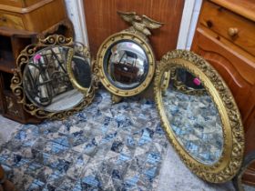 A group of three gilt framed wall mirrors to include a convex butler's mirror surmounted by an eagle