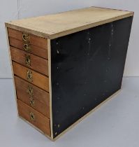 A watchmakers tool chest containing balance wheels, watch hands, movements and other wristwatch