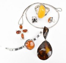 A silver-mounted amber cuff bracelet, with naturalistic design and central freeform polished