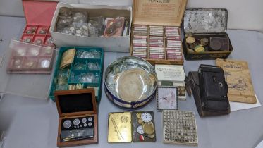 A mixed lot to include watch glasses, mainsprings, apothecary scales whale small lightbulbs,
