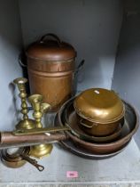 A mixed lot of copper and brassware to include a tea urn, pans, and a pair of candlesticks Location: