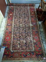 An early to mid 20th century Persian hand knotted runner, floral design on a black ground, triple