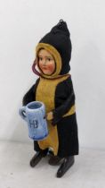 A 1930s Schuco toy of a child drinking monk Location: