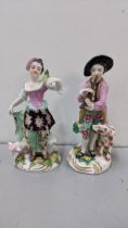 Two 19th century continental Chelsea style porcelain figures to include one of a boy playing the