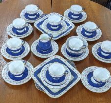 A Wedgwood part tea service with a blue ground decorated with flowers and a gold coloured band