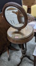 A late Victorian mahogany pedestal shaving stand, adjustable circular mirror, over a drum shaped