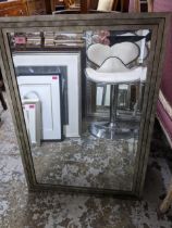 A contemporary framed wall mirror with bevelled glass plate 85.5cm x 60cm Location: