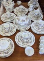 A Wedgwood dinner/tea service in the Lichfield pattern to include two platters, a treen, coffee cans