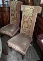 A pair of Victorian prie dieu chairs on rosewood legs and casters Location: