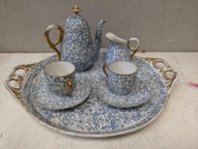 An early 20th century cabaret set with two cups and saucers, a teapot, a cream jug and tray