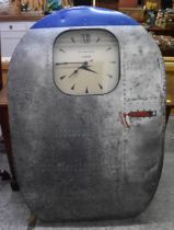 A De Havilland aircraft door fashioned as a wall clock, with aluminium exterior, the window with