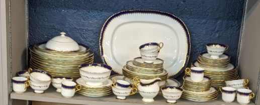 An early 19th/20th century Coalport cobalt blue and white dinner service having gold coloured