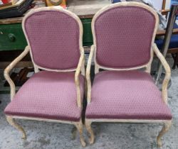 A pair of mid 20th century stained beech carved French style armchairs having floral carved frames