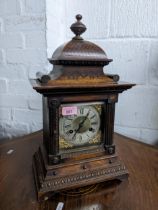 A Furnhams Victorian oak cased mantle clock, an ornate case housing a movement with silvered chapter