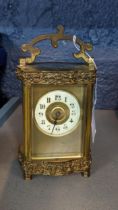 A 20th century brass cased carriage clock with pressed ornament Location: