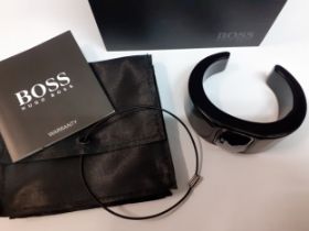 Hugo boss- A modern black plastic bangle with central rectangular and faceted silver coloured