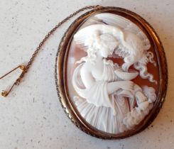 A pinchbeck cameo brooch of Hebe The Goddess of Youth and The Eagle of Justice in a gilt metal frame