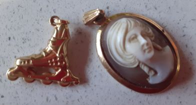 A small 9ct gold cameo pendant stamped 375 and a small 18ct gold charm in the form of an inline-